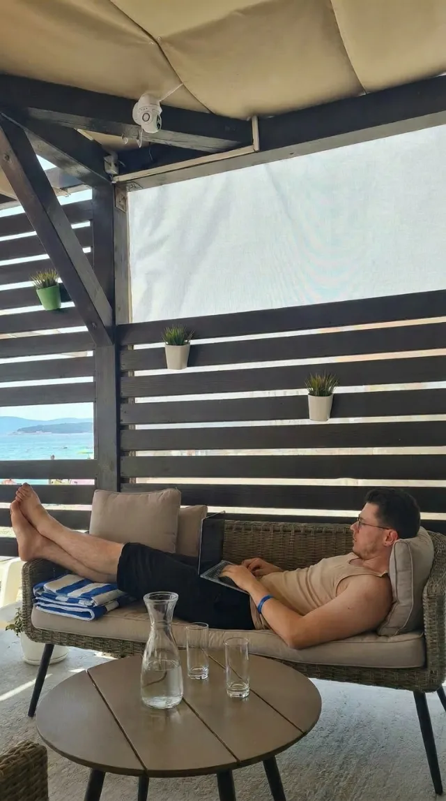 Working seaside with a laptop, feet up